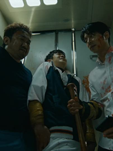 Gong Yoo, Ma Dong-Seok e Choi Woo-shik nei ruoli di Seok-Woo, Sang-Hwa e Young-Gook in Train to Busan.