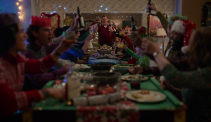 Jeremy Swift as Leslie Higgins makes a speak at the table where AFC Richmond and his family are celebrating Christmas in Ted Lasso Carol of the Bells